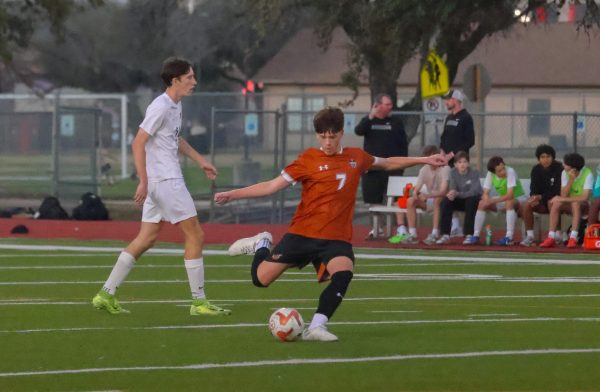 Preparing to kick the ball after a penalty, Nate Gunderson '27 sends the Warriors down the field. The penalty kick gave the Warriors the position needed to score.