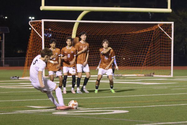 Preparing to stop the ball, Rahul Kuthiala '25, Kaz Seyhoon '26, Caleb Fagan '25, and Nico Hamelin '27 form a defensive wall. Multiple penalty kicks were awarded to both teams throughout the game.