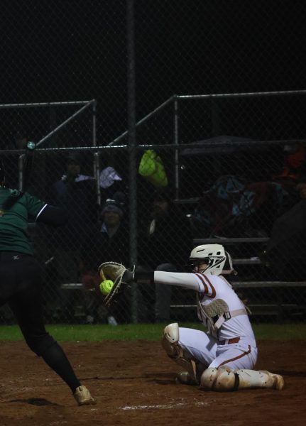 Abby Thailing '26 catches strike ball thrown by Clare Guidry '27 when one of the Cedar Park Timberwolves was up to bat.