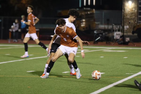 Blocking his opponent, Caleb Fagan ‘25 positions himself to gain possession of the ball. Fagan was in the starting lineup and was an essential player who was always open for a pass. 