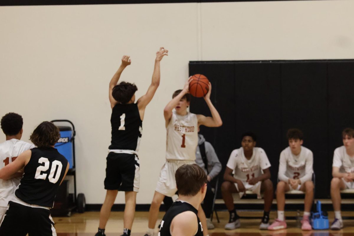 Thomas Story, '28, is blocked by opposing player while he has possession of the ball.