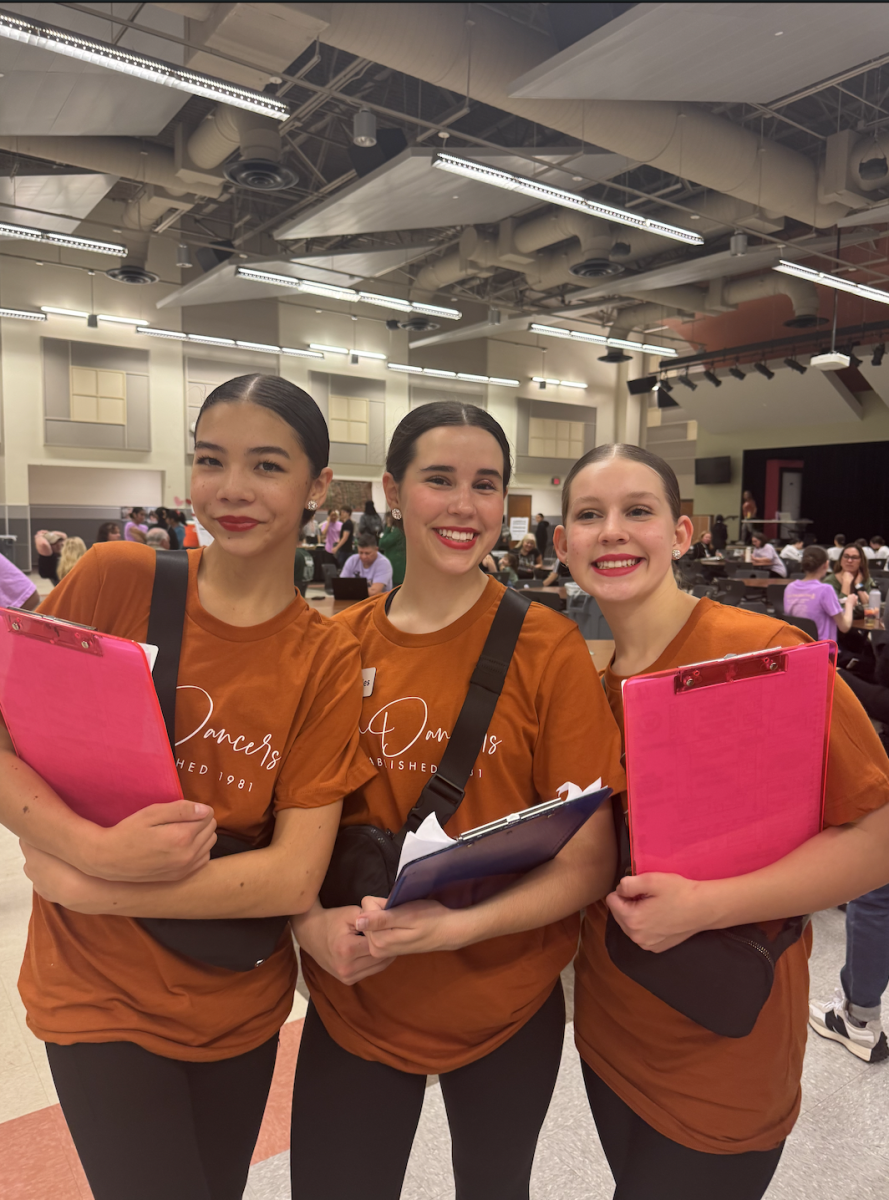 Organizing the practice lineup for the Central Austin Dance Challenge, Magdelyne Hang ‘28, Molly Johnson ‘28, and Bethany Kannar ‘28 help coordinate schedules with the teams. As SunDancer newbies this was their first time fully participating in a SunDancer run event. “Newbies class doesn't have a lot of commitment yet because we’re just learning the ways of SunDancers,” Hang said. “It was a good introduction to see how the team works.” 
 