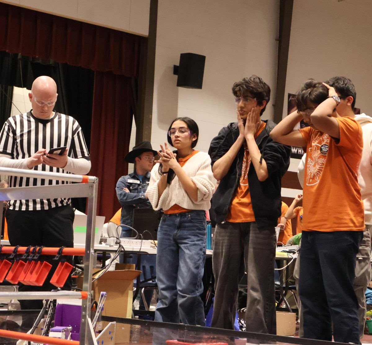 Distressed, Rupal Jain ’27, Arhaan Jafri ’27, and Souren Uchat ’26 of Team Slingshot anxiously await the final score after a match. Having driven their team’s robot all season, the trio built strong chemistry and teamwork, however, the cancellation of the State Championship has made their journey to the World Championship much more difficult.