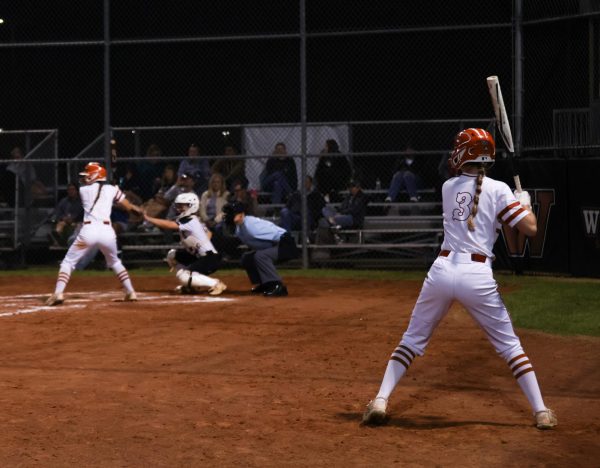 Preparing to bat next, Everleigh Bymark '28 watches her teamate up at the plate. The Lady Warriors made sure to cheer eachother on through the tougher innings. 