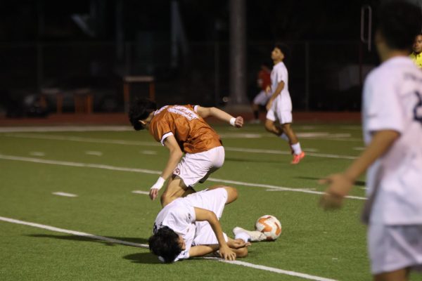 Leaning over, Santiago Pena '27 looks for the ball. Pena assisted 2 goals during the game.