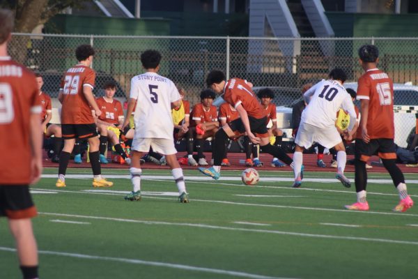 Maneuvering the ball, Nate Gundersen '27 attempts to break through the opposition near the midfield.