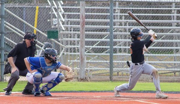 Coming out of a forward stance, Sterling Woodley '26 relaxes after a strike. The catcher held the ball as Westwood amassed another strike, but Woodley made a comeback, scoring the Warriors another point.