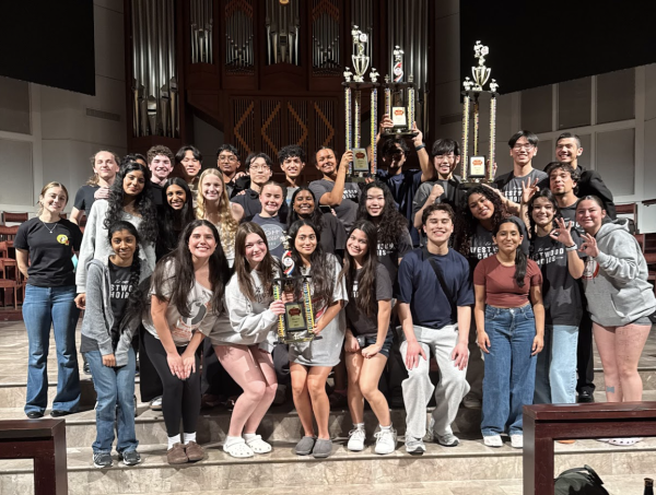 The choir proudly displays their hard earned trophies after a long performance. 
