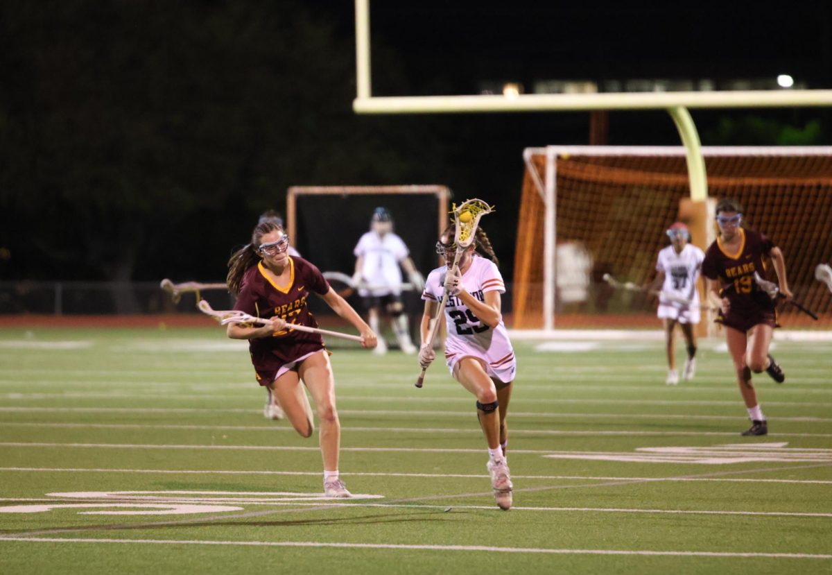 Racing down the field Audrey Coplen '26 swiftly dodges the defender. The Menlo-Atherton Bears came from California to compete with the Warriors. 
