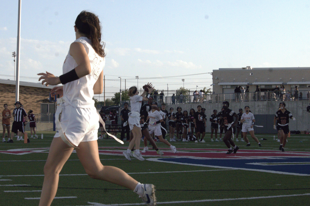 Leaping to catch a pass from her quarterback, Paige Price '27 catches the ball for the first down. After a quick lived first half, through the second half Price consistently found openings in the Hutto defense.