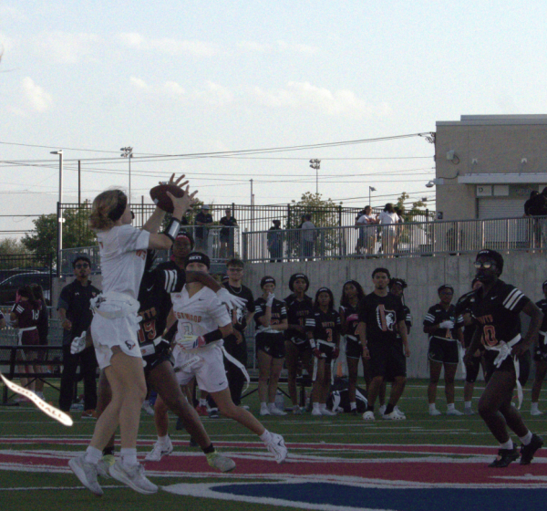 Leaping to catch a pass from her quarterback, Paige Price '27 catches the ball for the first down. After a quick lived first half, through the second half Price consistently found openings in the Hutto defense.