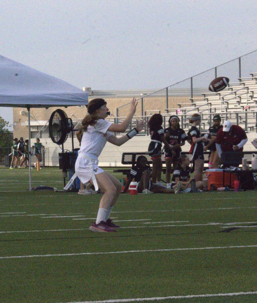 Warming up for the Warriors' sixth game, against the Weiss Wolves, Ana Correa '27 is hit for a short hook route to prepare for the game ahead. Later, as the game progressed, the Warriors repeatedly returned to this pass as a way to keep the ball moving away from the defense.