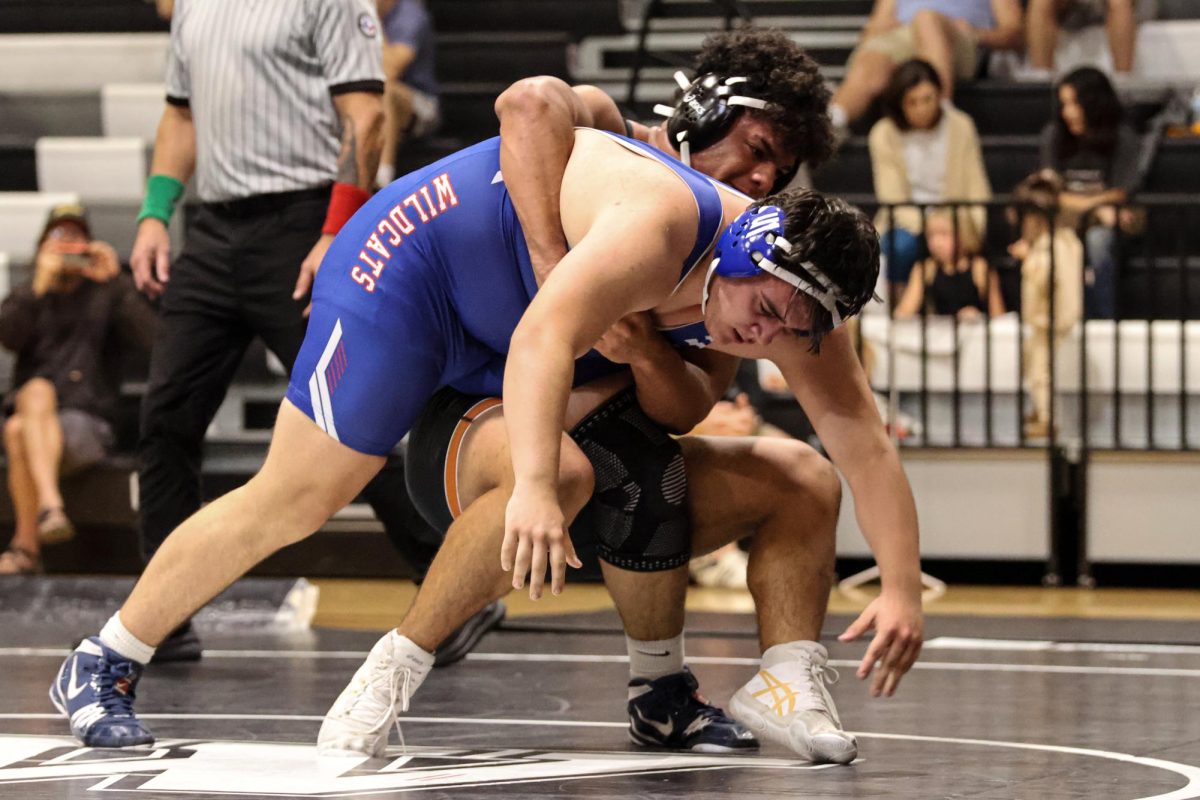 Using his strength, Elijah Sanchez '26 lifts a Temple wrestler up in the air before slamming him back to the mat. "[In] my head, it was like this Tiktok sound playing, 'bon voyage! What goes up must come down'," Sanchez said.