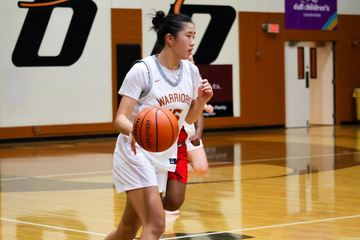 Ball in hand, Iman Xu '28 moves swiftly towards her teammates in the Warrior half. Xu was instrumental in gaining consistent points for her team throughout the game. 