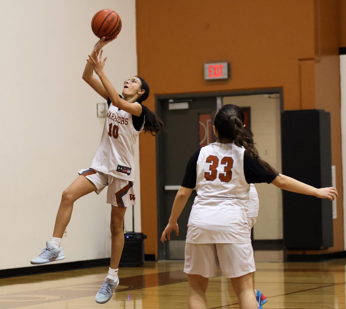 Eyes on the ball, Valentina Chapa '29 puts up a layup to score a basket. Not only did the Warriors push off strong on offense during the game against Mustangs, they also took a tight man-to-man approach on defense, allowing them to have multiple steals. "I think we did great," Chapa said. 