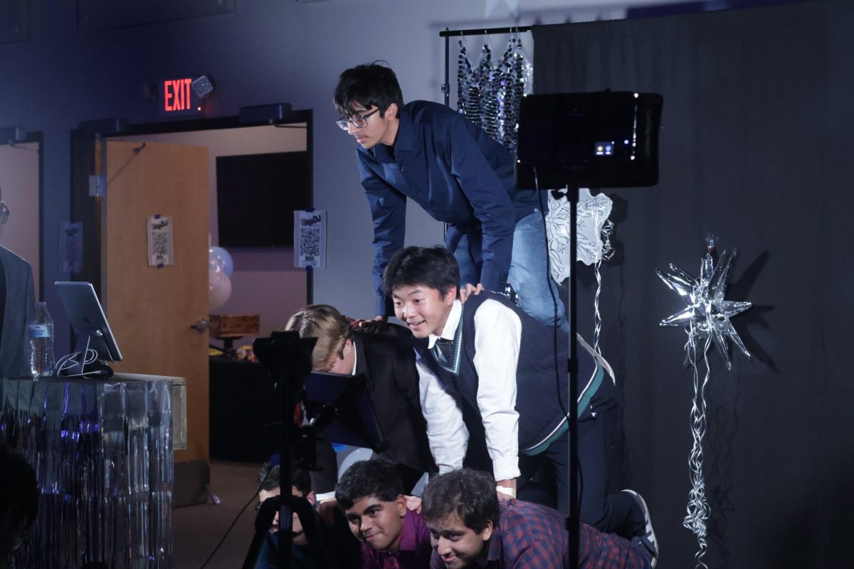 Stacked on top of one another, IB students get creative at the photo booth. The photo station was set up by IB student Aaron Yeh '26 and was used by many attendees. 