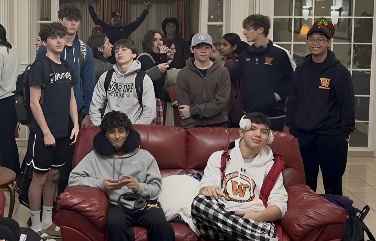 The Wrestling team huddles up for a picture as they prepare to leave their motel. The ride to Bryan was over two hours, prompting the team to stay overnight so they could make the tournament's morning start.