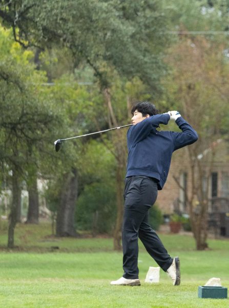 Edward Jung '26 practices his swing for his next par. As a senior, Jung makes sure to do a couple practice swings before hitting the ball. "I was able to send that ball pretty far, it went straight into the fairway." Jung said.