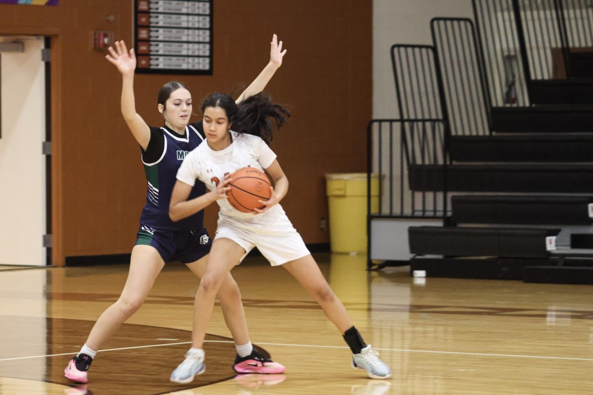 Trying to pivot out of the Maverick's defense, Varsha Shiva Ram '29 lunges last minute to make a pass to a teammate. The Warriors played hard and stayed quick on their feet in the fast-paced game. 