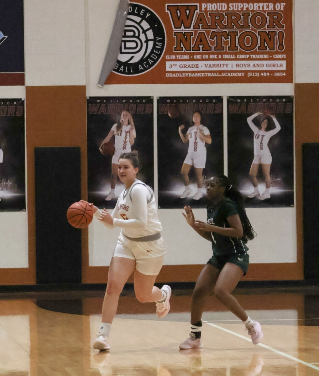 Swiftly sweeping by, running down court in transition Vivian Hapka '26 protects the ball against Mcneil defense. During the Warriors battle against Mcneil, transitions were a constant struggle for both teams as both played tight, suffocating defense.