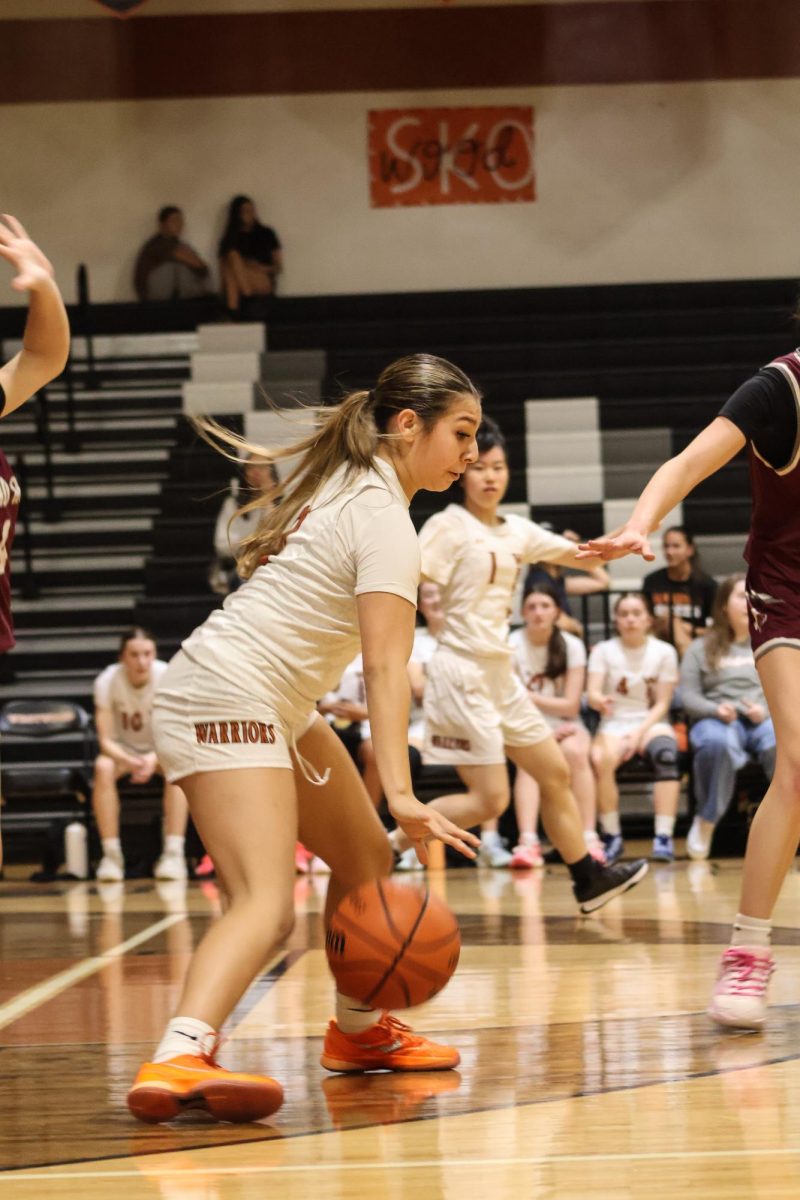 Guarded by two Dragons, Julissa Rodriguez focuses on a way out. Despite falling short a few points, the team's chemistry and attentiveness allowed them score multiple baskets. 