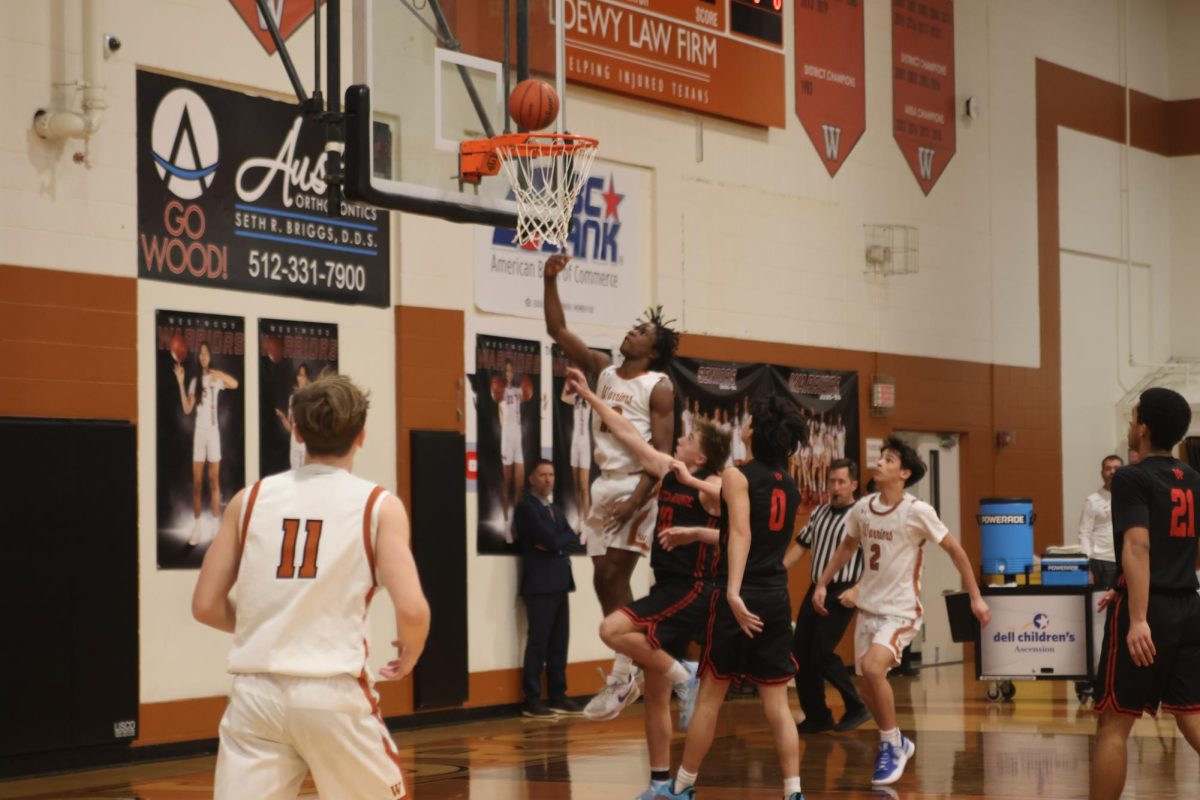 In motion, Khalil Alexander '26 rises above and releases a layup. Alexanders' shot-making ability near the rim increases the Warriors offensive pressure during this game.