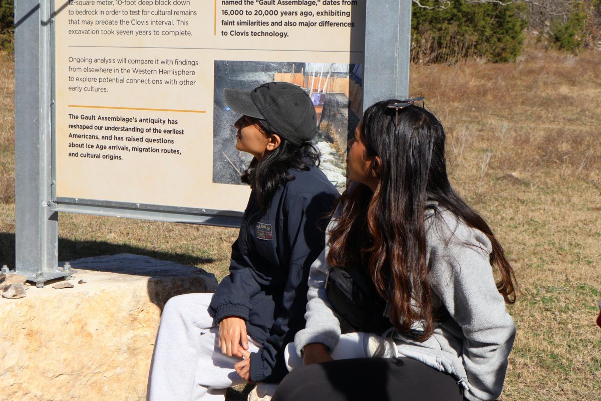 Looking towards their guide, seniors Aanya Ujjval and Satchi Patki learn about the excavation techniques used at the Gault site. The experience was guided by the posters around the site which contained detailed information. 