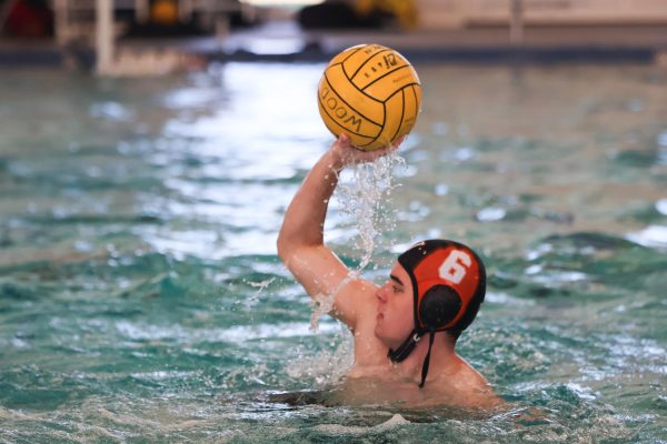 Eyeing the goal, Caden Bradford '26 aims to shoot a goal. A consistent scorer, Bradford helped the Black team dominate in the water. 