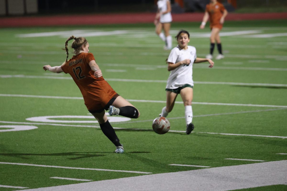 Lining up her leg for the kick, Charlotte Holland '27 tries to push the ball upfield. The Warriors used communication and teamwork to power through their first home game of the season. 