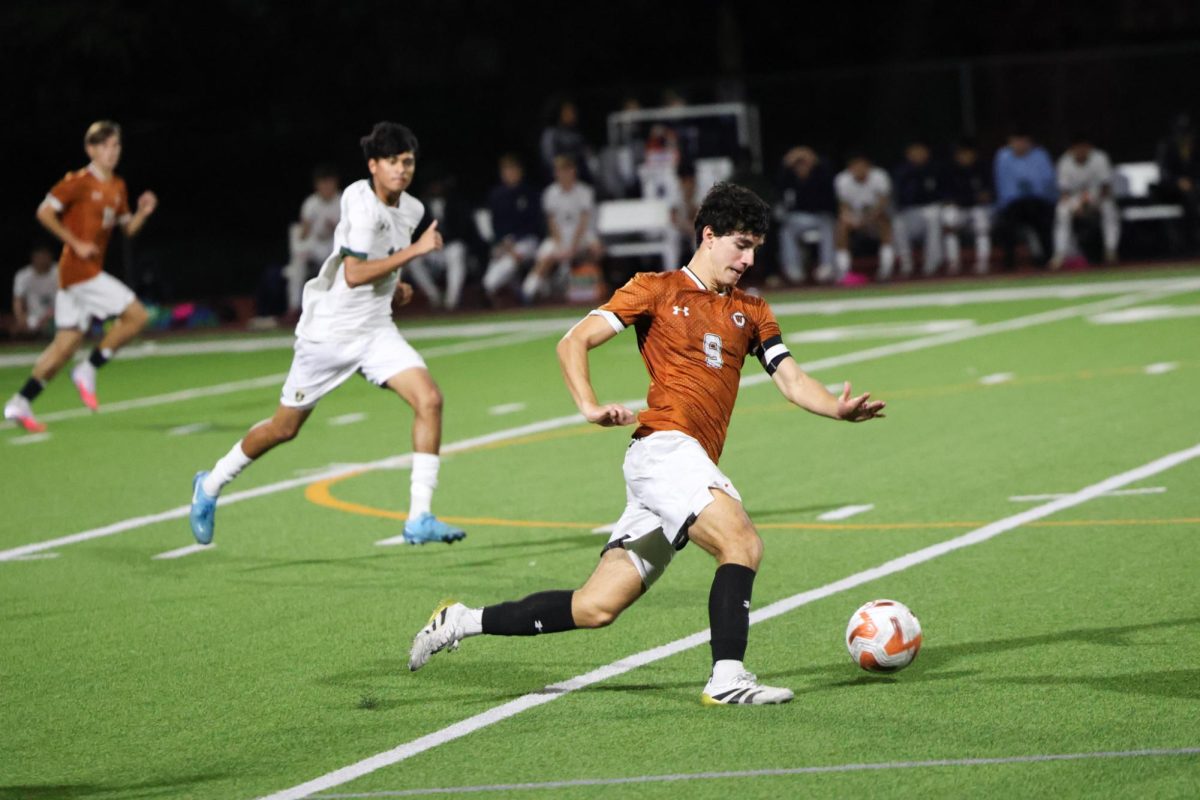 Sprinting forward with the ball, Rodrigo Garcia '26 runs down the wings after a clearing by Westwood defense. Throughout the game, Westwood defense cleared many balls to their forwards' to help make attempts at a goal. 