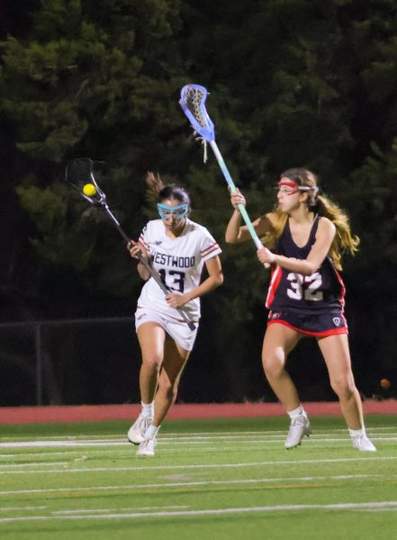 Ball in her stick, Ayman Halai '27 speeds past a Bowie rival. Halai's quick offense led to her position as a JV Captain. 