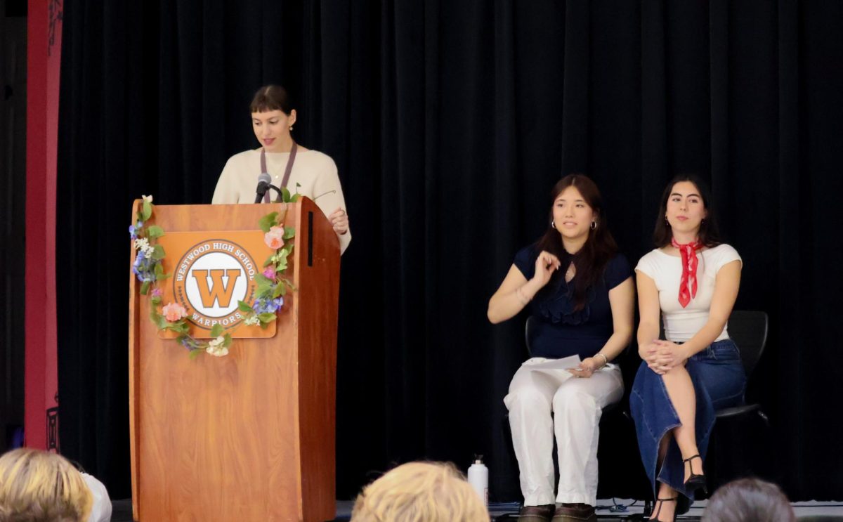 Looking at her speech, SHF sponsor Mme. Sarah Le Pichon addresses the inductees and their family members. Mme. Le Pichon's speech emphasized the hard work that the inductees had put in and highlighted the accomplishment of joining the French Honor Society. 