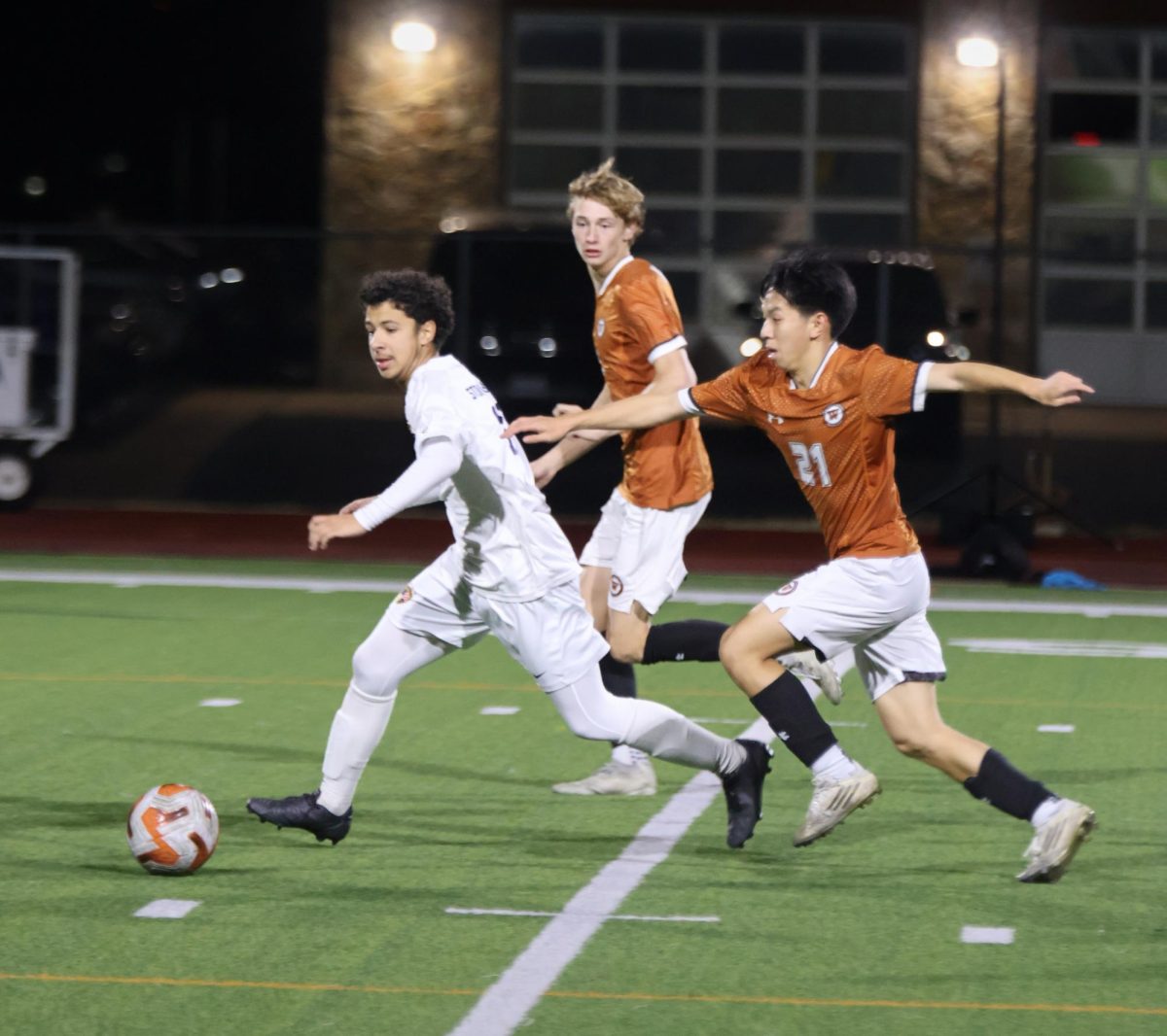 Chasing after an opponent, Aidan Shen '26 sprints towards the ball. Shen had multiple defensive plays to help solidify the win.