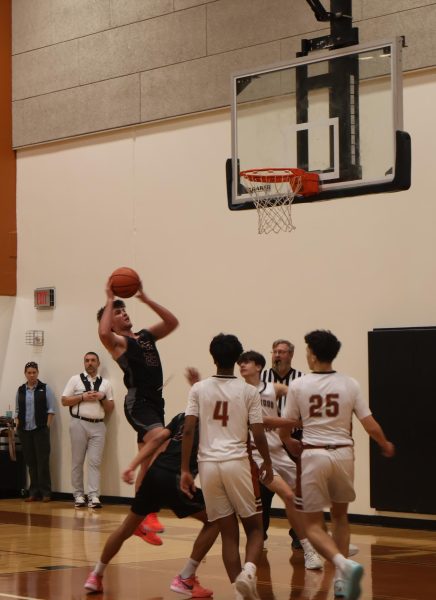 Preparing to block ten Dragons chance of furthering a score, Sanjiv Doraisamy '29 locks down on defense. Despite, defensive efforts the Dragons miss no opportunity to leap into points.