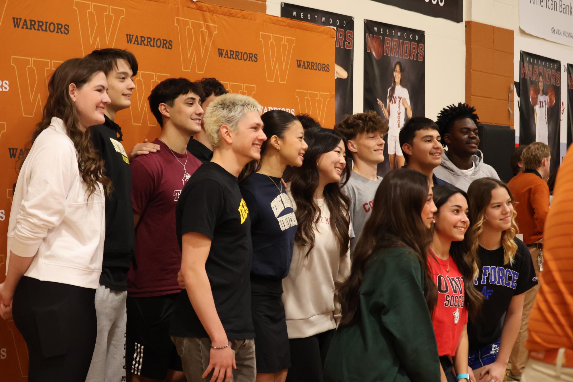 Huddled in unison, all, now signing, Westwood athletes in the class of 2026 join together for one last picture on their special day. In total, over 12 Warriors participated in this event and will go on to play in the collegiate level. 
