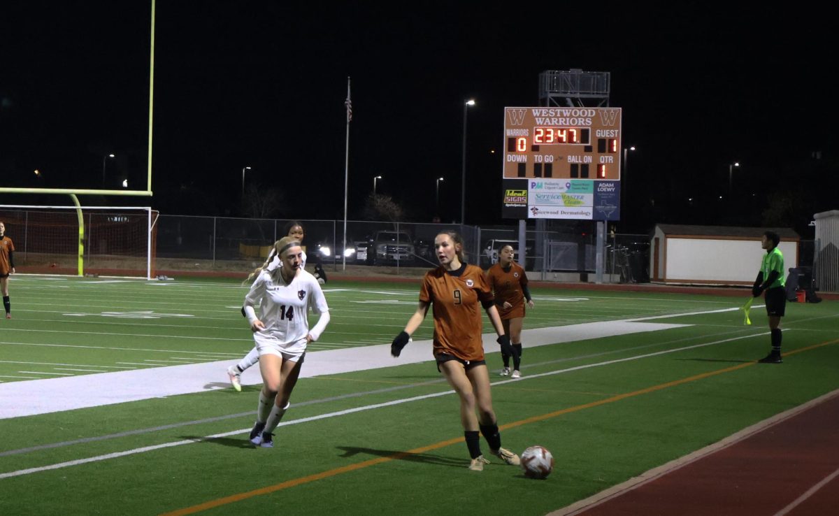 On the lookout, Payton Vopat '26 scans the field for an open player to pass the ball. The Warriors utilized their communication skills throughout the game, leading to a hard-fought 1-1 score. 