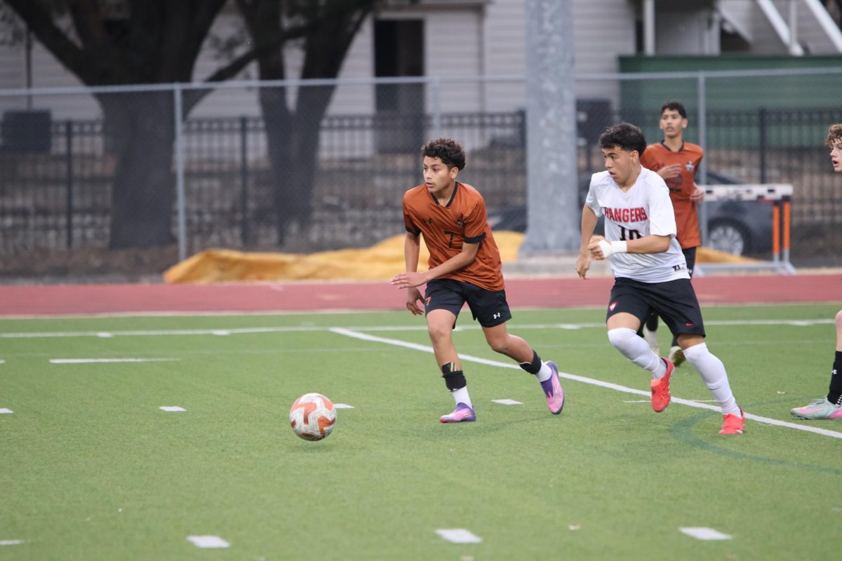 Against the heavy wind, Adrian Mendoza '29 pushes forward towards the goal. As a midlfielder, he was responsible for a majority of the throw-ins. 