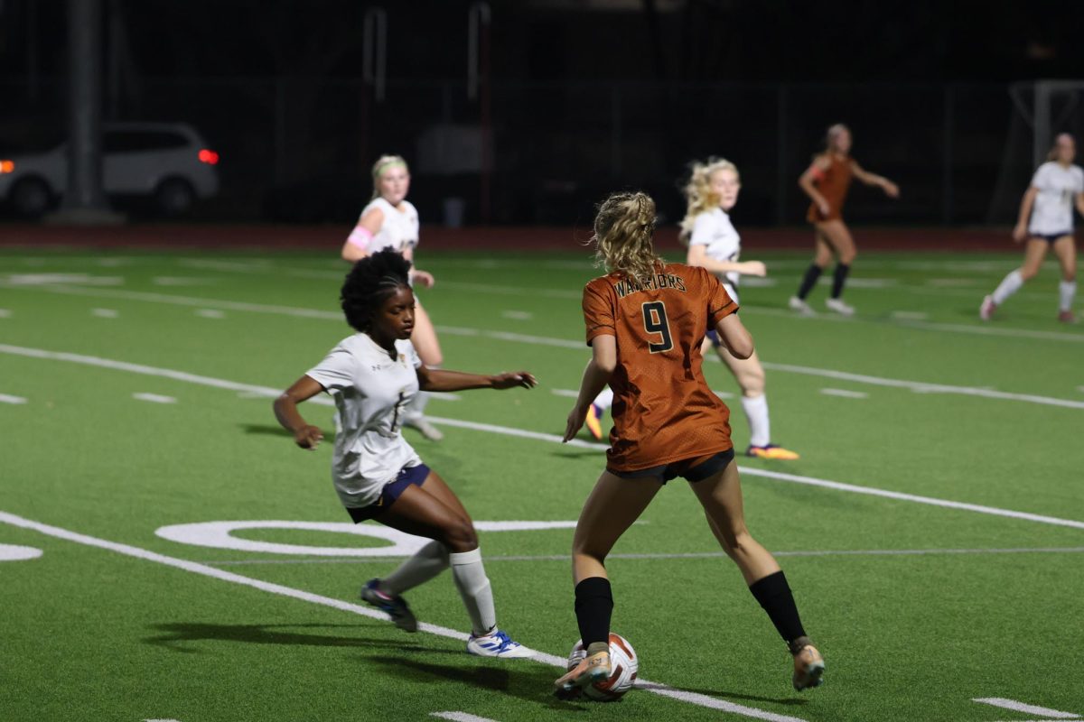 Weaving past the incoming Tiger defender, Payton Vopat '26 wields her strength and speed to dominate possession for the  Warriors. The bulk of the night saw the ball consistently in the Warriors clutches, enabling them to make consistent goal attempts. 