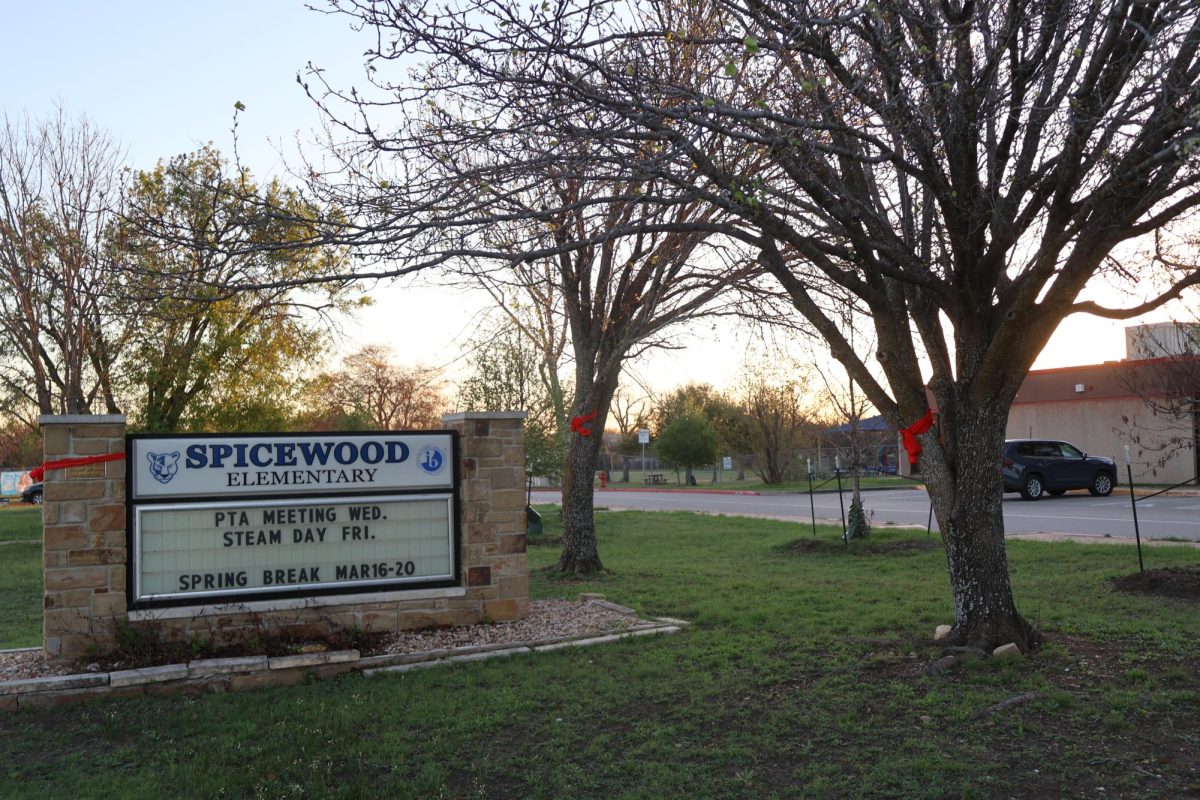 Sunlight streaming through the branches, red ribbons decorate the trees and poles outside of Spicewood Elementary School. Community members were asked to tie "Red Ribbons for Ryder" to celebrate the life of Ryder Harrington '24, who lost his life to the Sixth Street shooting. "If you drive past Spicewood, every tree, every pole, everything that you can tie something around is covered in red ribbons," Saloni Chitari '28 said. "It just made me see how truly connected we were as a community to celebrate the life of someone who died too early."