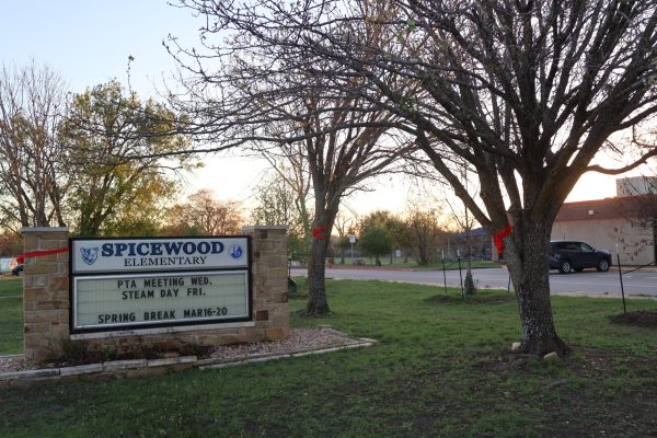 Sunlight streaming through the branches, red ribbons decorate the trees and poles outside of Spicewood Elementary School. Community members were asked to tie "Red Ribbons for Ryder" to celebrate the life of Ryder Harrington '24, who lost his life to the Sixth Street shooting. "If you drive past Spicewood, every tree, every pole, everything that you can tie something around is covered in red ribbons," Saloni Chitari '28 said. "It just made me see how truly connected we were as a community to celebrate the life of someone who died too early."