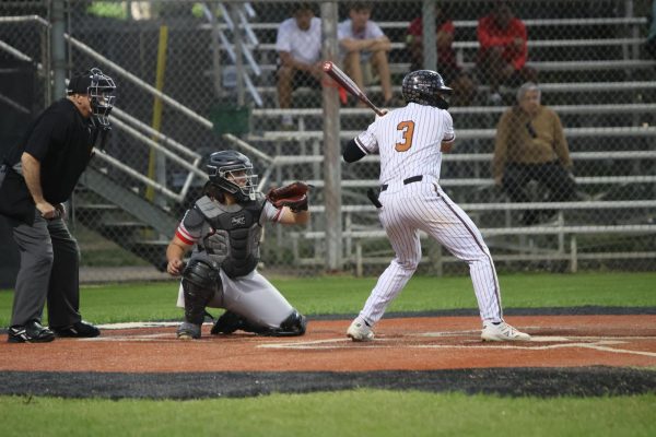 Preparing to swing, Antonio Martinez '26 looks the pitcher in the eye. Martinez's batting capabilities were part of a team effort that resulted in the 14-0 blowout. "I feel that I hit very well. I went 2 for 3 of the plates, so it was a good day," Martinez said.