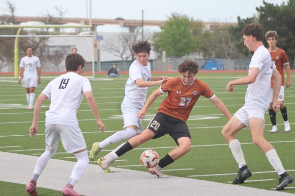 Surrounded by Viper players, Samuel Givens ‘27 tries to escape while maintaining Warrior possession. He helped significantly in moving the ball forward throughout the game.