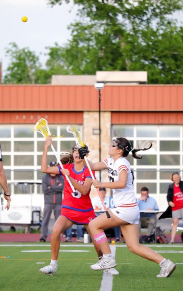 Launching her stick upwards, Ana Jovanovic '27 battles with a Westlake Chaparral for the ball following the draw. Due to the Chaparrals' intense offensive abilities, Jovanovic had to adapt to certain draw cues for the best chance of winning the first possession. 