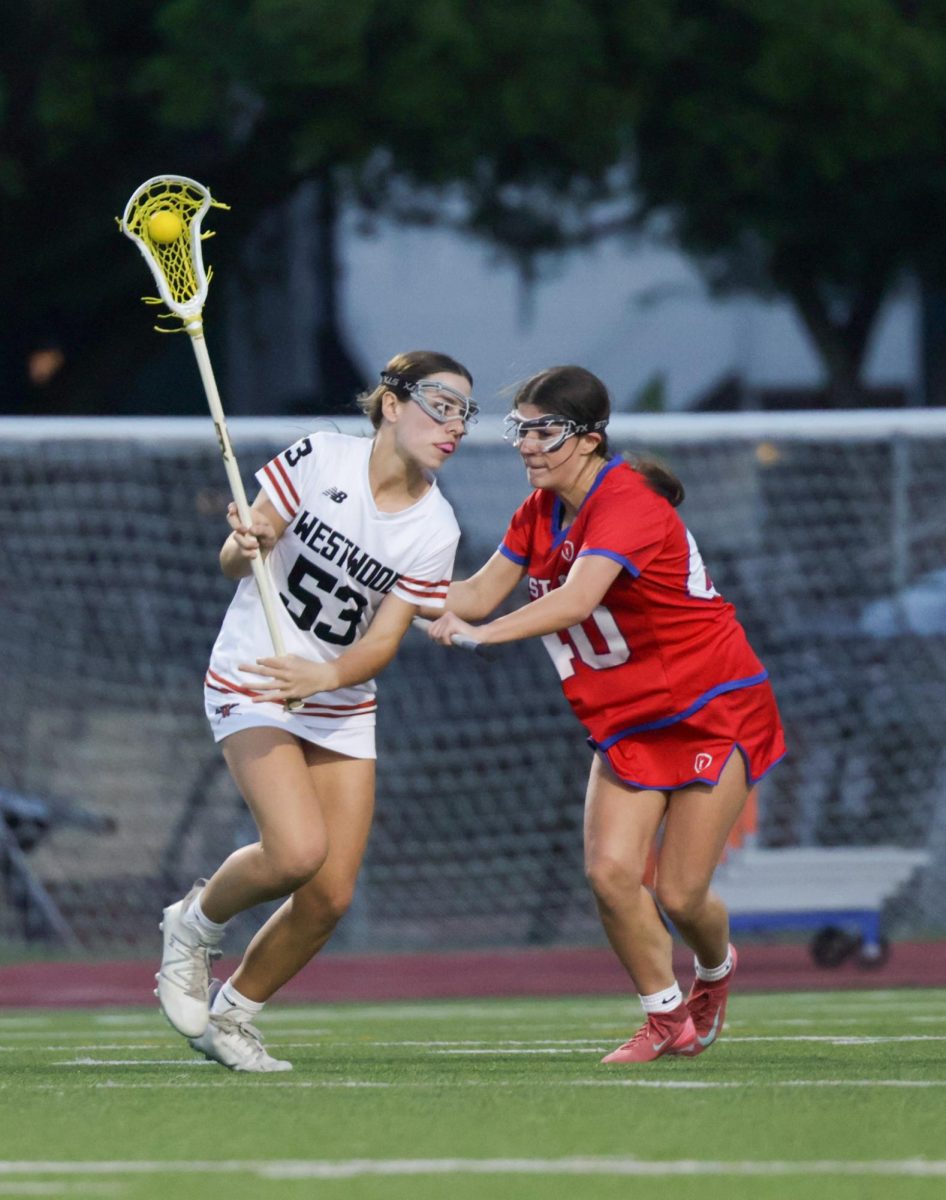 Eyes focused on the goal, Bonnie Rose Hance '29 narrowly avoids Westlake's aggressive attack. Despite their aggressive manner, Hance evaded being provoked in order to not get a foul. "I made a bet with my coach to see if I couldn't foul, and I won," Hance said.