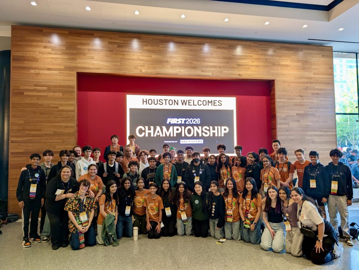Huddled together at the end of the competition, Westwood Robotics teams Orange Dynamite and Slingshot celebrate the end of the Worlds competition. Working closely together throughout the season, the team members had become close knit and used the competition as a way to celebrate their hard work. 