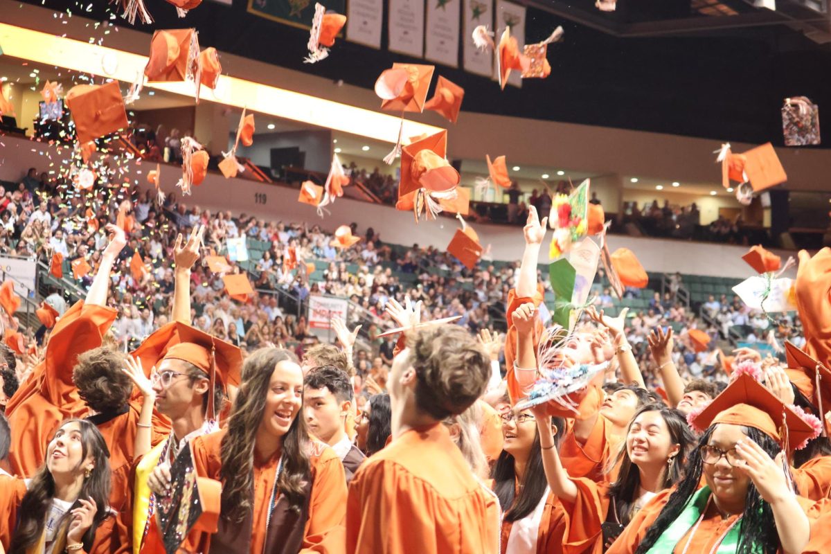After moving their tassels to the left side of their cap, graduates gleefully throw their caps into the air. This final gesture symbolized the seniors' release from an arduous but meaningful high school journey. 