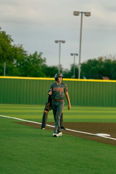 Looking on, Justice Moore '26 stands at second base. Justice's time as baseball team captain was exemplified by his constant drive for success and dedication to teammates.