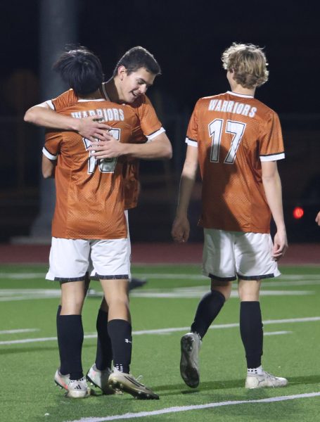Hugging a teammate, Charles Walker '27 celebrates a goal. As team captain, Charles made it a goal to encourage his team and always push them to be their best.